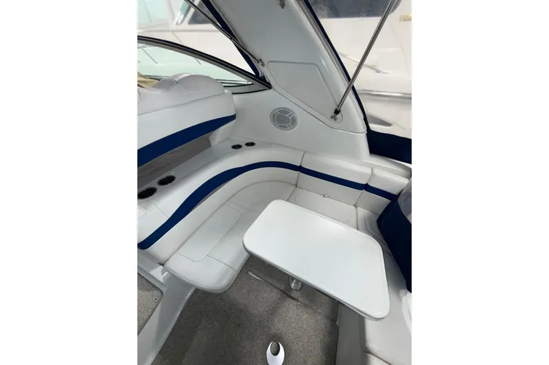  Yacht Photos Pics 2004 Formula 34 Performance Cruiser interior with white and blue seating and table.