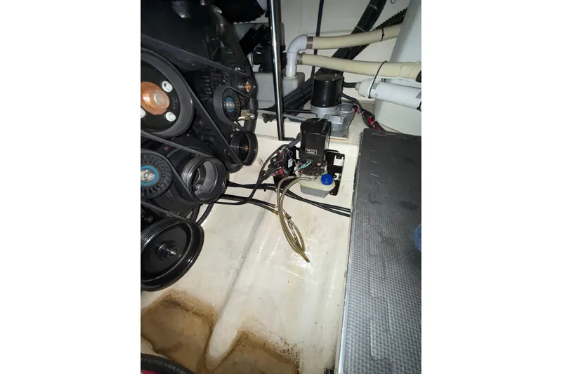  Yacht Photos Pics Engine compartment of a 2004 Formula 34 Performance Cruiser, showing belts and mechanical components.