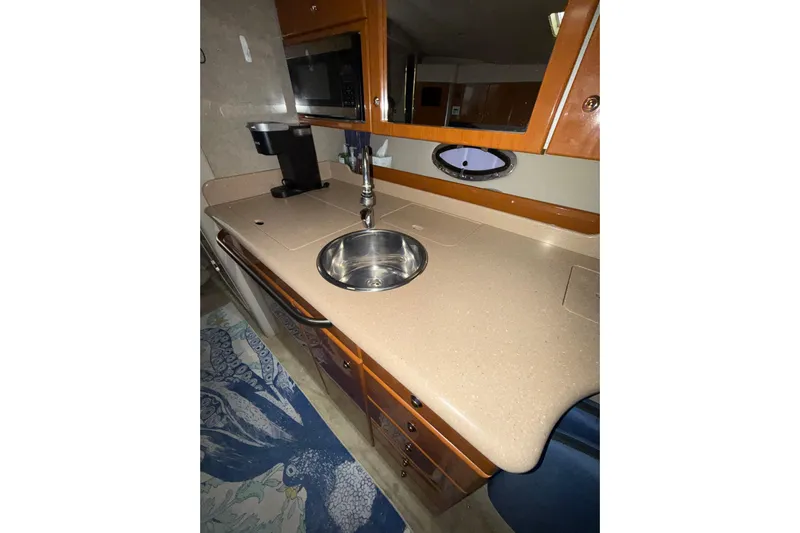  Yacht Photos Pics 2004 Formula 34 Performance Cruiser kitchen with sink, microwave, and storage cabinets.