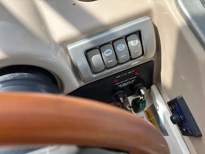 Cookin' Yacht Photos Pics Control panel of a 2008 Formula 37 PC boat with switches and steering wheel.