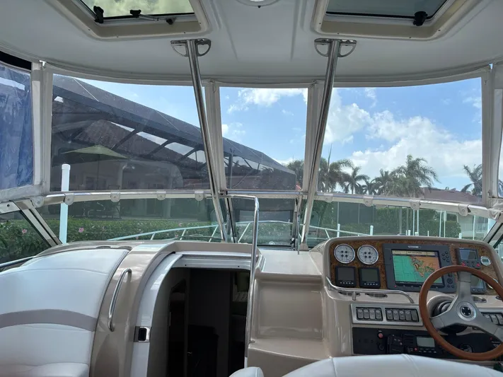 Cookin' Yacht Photos Pics Interior view of 2008 Formula 37 PC yacht cockpit with navigation controls and open cabin door.