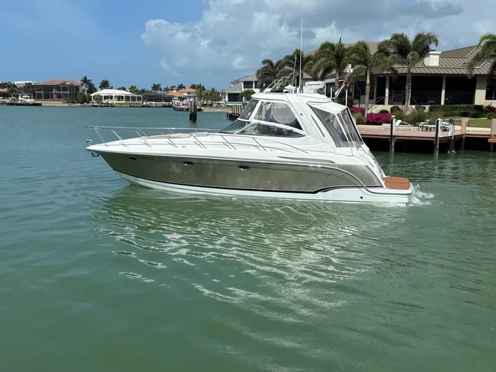 Cookin' Yacht Photos Pics 2008 Formula 37 PC yacht cruising in a scenic waterfront area.