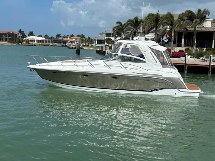 Cookin' Yacht Photos Pics 2008 Formula 37 PC yacht cruising in a tropical marina with palm trees.