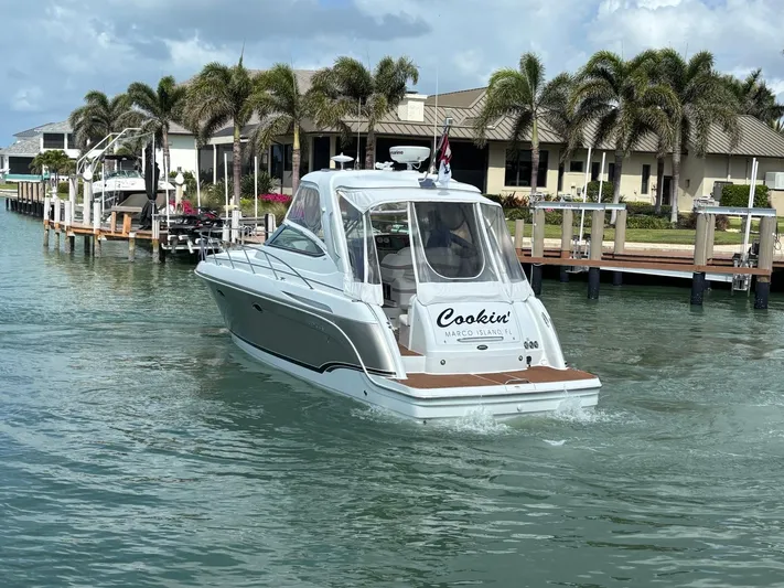 Cookin' Yacht Photos Pics 2008 Formula 37 PC yacht cruising in a tropical marina with palm trees.
