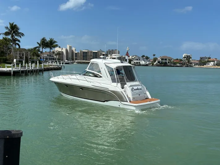 Cookin' Yacht Photos Pics 2008 Formula 37 PC yacht cruising in a sunny coastal marina.