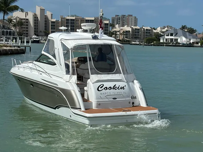 Cookin' Yacht Photos Pics 2008 Formula 37 PC yacht cruising in a marina with waterfront buildings in the background.