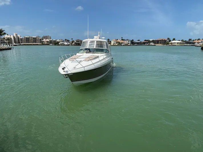 Cookin' Yacht Photos Pics 2008 Formula 37 PC yacht cruising in a serene, tropical bay.