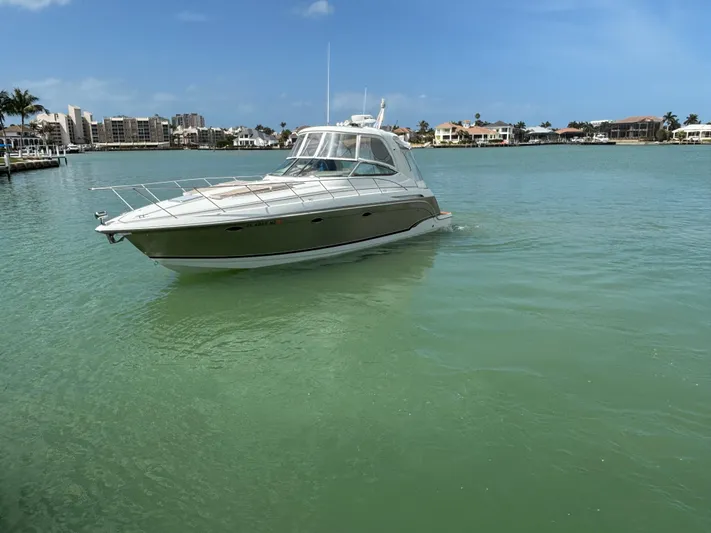 Cookin' Yacht Photos Pics 2008 Formula 37 PC yacht cruising in a serene, tropical bay with clear skies.