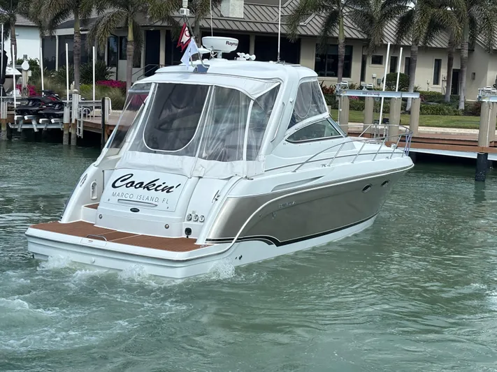 Cookin' Yacht Photos Pics 2008 Formula 37 PC yacht cruising in a marina, featuring sleek design and clear canopy.