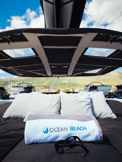 Duolife Yacht Photos Pics Luxurious Lagoon 620 Essence yacht deck with pillows, towel, and sunglasses, 2019 model.