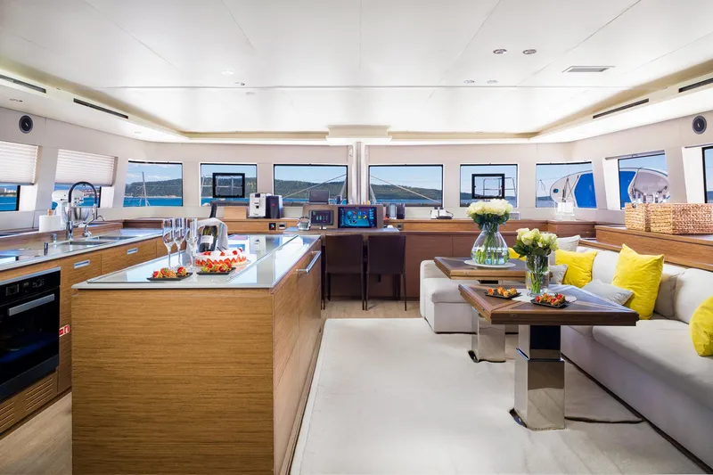 Duolife Yacht Photos Pics Luxurious interior of 2019 Lagoon 620 Essence yacht with modern kitchen and elegant seating area.