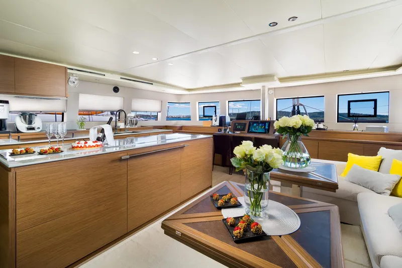 Duolife Yacht Photos Pics Luxurious interior of 2019 Lagoon 620 Essence yacht with modern kitchen and elegant decor.