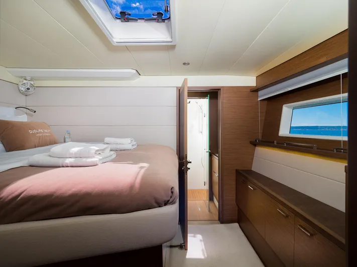 Duolife Yacht Photos Pics Luxurious cabin interior of 2019 Lagoon 620 Essence yacht with skylight and ocean view.