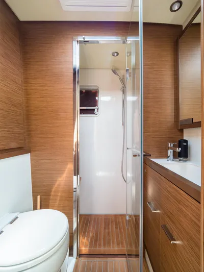 Duolife Yacht Photos Pics Luxurious bathroom interior of 2019 Lagoon 620 Essence yacht with wood finish and modern fixtures.