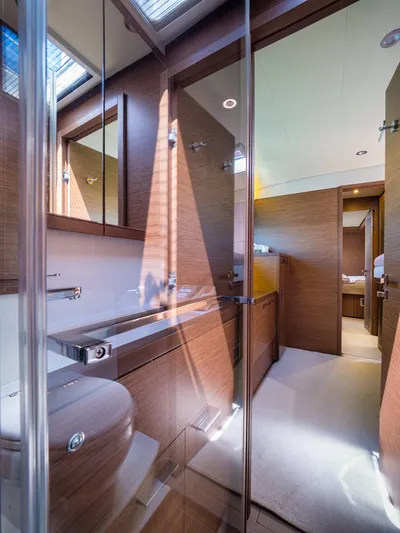 Duolife Yacht Photos Pics Luxurious bathroom interior of 2019 Lagoon 620 Essence yacht, featuring modern wood finishes and skylight.