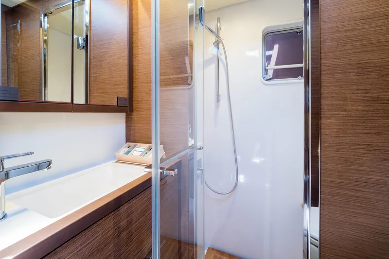 Duolife Yacht Photos Pics Luxurious bathroom in 2019 Lagoon 620 Essence yacht with modern fixtures and wooden accents.