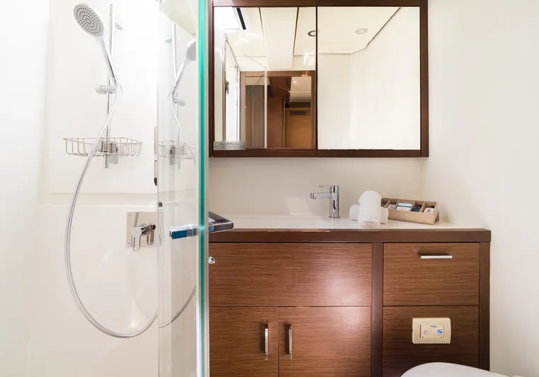 Duolife Yacht Photos Pics Luxurious bathroom in 2019 Lagoon 620 Essence yacht with modern fixtures and wooden cabinetry.