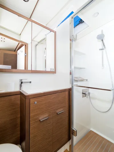 Duolife Yacht Photos Pics Luxurious bathroom in 2019 Lagoon 620 Essence yacht with modern fixtures and wooden cabinetry.