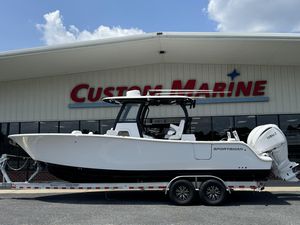 2025 Sportsman Open 282 Center Console boat on trailer at Custom Marine dealership.