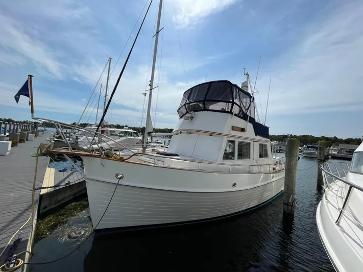 Meritage Yacht Photos Pics 1990 Grand Banks 42 Classic yacht docked at marina under clear sky.