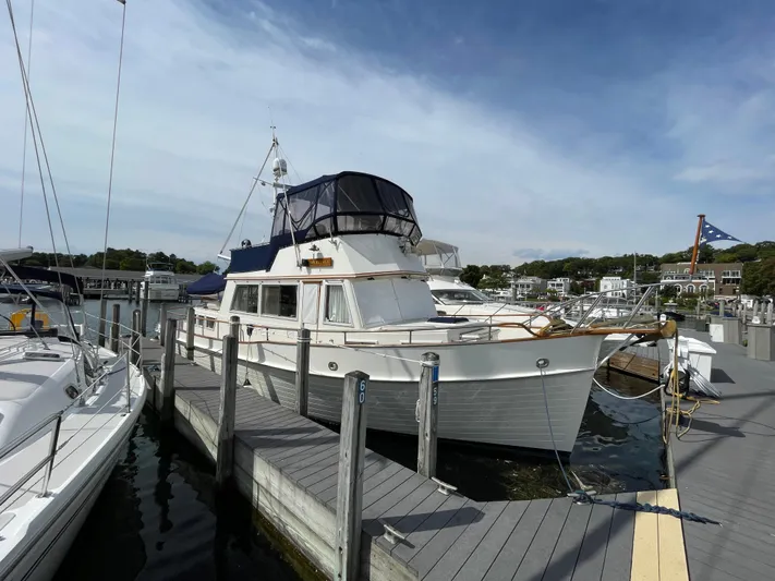 Meritage Yacht Photos Pics 1990 Grand Banks 42 Classic yacht docked at a marina under a clear sky.