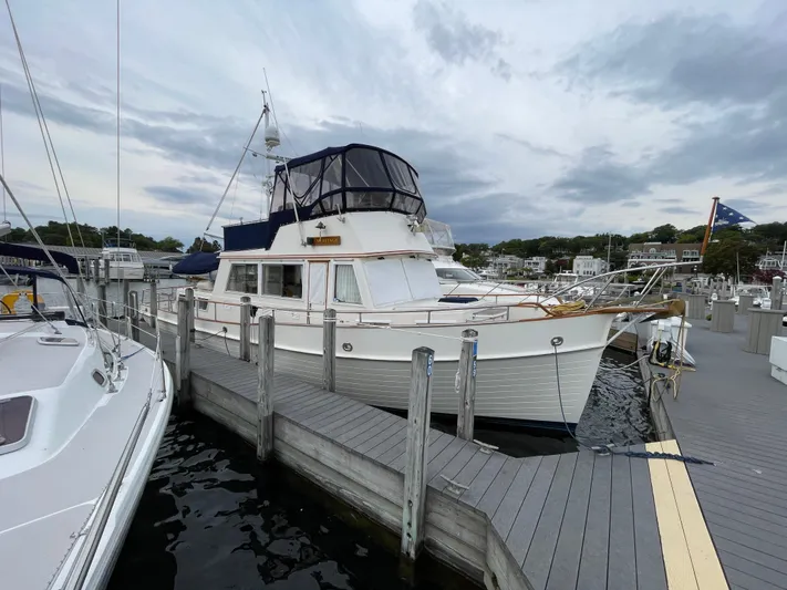 Meritage Yacht Photos Pics 1990 Grand Banks 42 Classic yacht docked at a marina under cloudy skies.