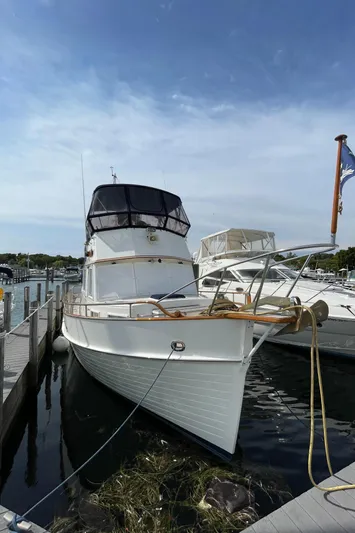 Meritage Yacht Photos Pics 1990 Grand Banks 42 Classic yacht docked at marina under clear sky.