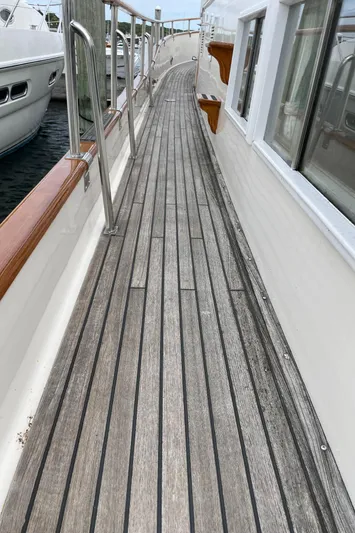 Meritage Yacht Photos Pics Teak deck of 1990 Grand Banks 42 Classic yacht with stainless steel railings.