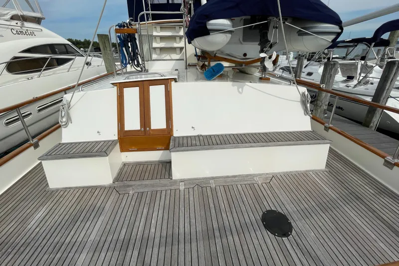 Meritage Yacht Photos Pics Grand Banks 42 Classic 1990 yacht deck with wooden flooring and seating area.