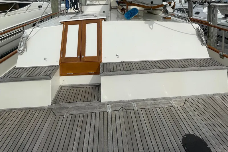 Meritage Yacht Photos Pics 1990 Grand Banks 42 Classic yacht deck with wooden seating and storage compartments.