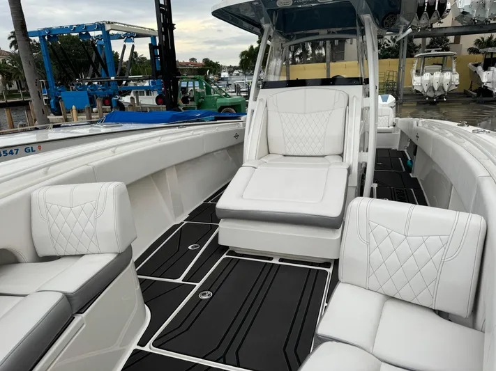Re-powered-2022 Yacht Photos Pics 2019 Fountain 38 CC boat with luxurious white seating and sleek design.