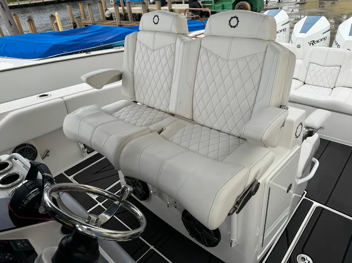 Re-powered-2022 Yacht Photos Pics Luxurious white seating on 2019 Fountain 38 CC boat, featuring diamond stitching and sleek design.