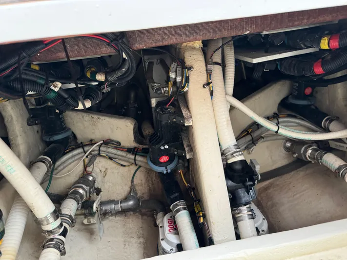 Re-powered-2022 Yacht Photos Pics Engine compartment of a 2019 Fountain 38 CC boat, showcasing wiring and plumbing.