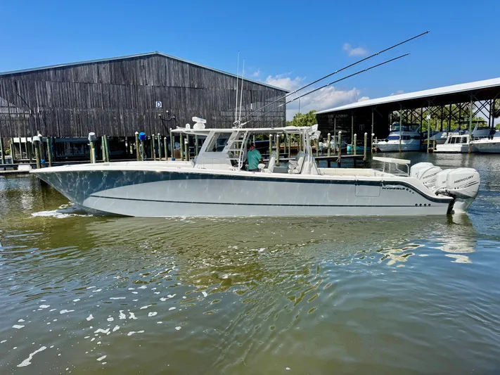  Yacht Photos Pics 2022 Invincible 46 Catamaran docked at marina, clear sky, calm water.