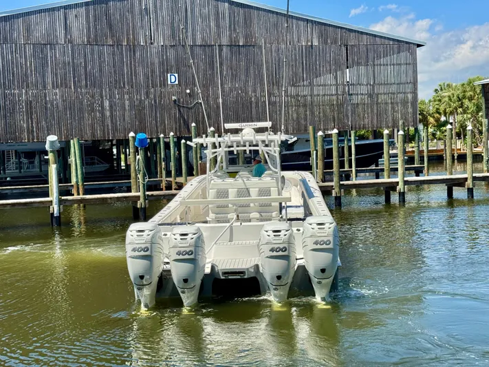  Yacht Photos Pics 2022 Invincible 46 Catamaran with quad engines docked at marina.
