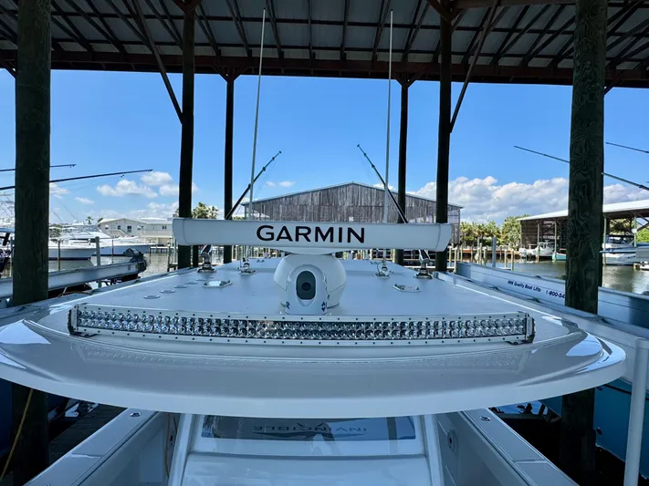  Yacht Photos Pics 2022 Invincible 46 Catamaran with Garmin equipment docked under a covered marina.