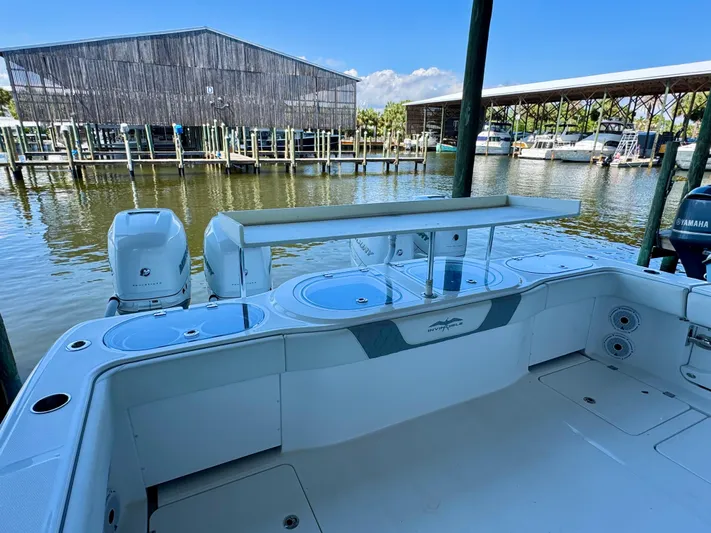  Yacht Photos Pics 2022 Invincible 46 Catamaran at marina, featuring spacious deck and dual engines.