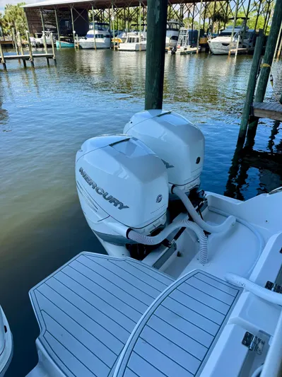  Yacht Photos Pics 2022 Invincible 46 Catamaran with twin Mercury outboard engines docked at marina.