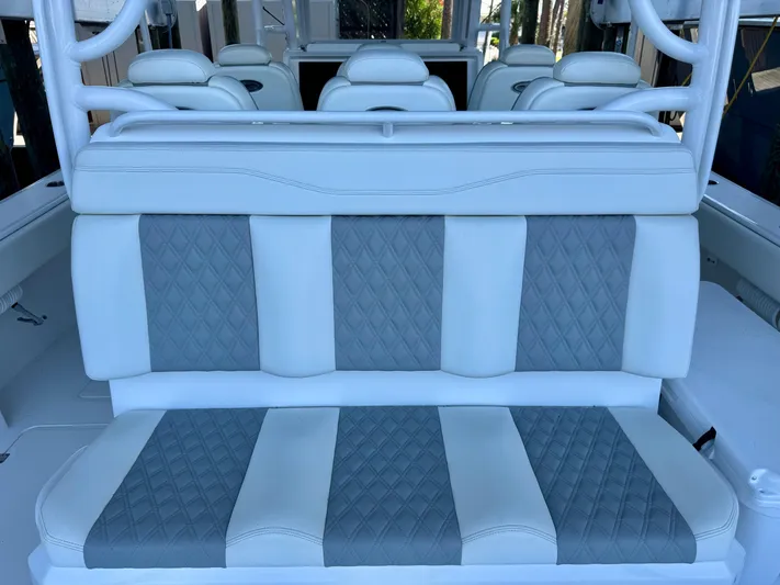  Yacht Photos Pics Luxurious seating on 2022 Invincible 46 Catamaran, featuring elegant white and gray upholstery.