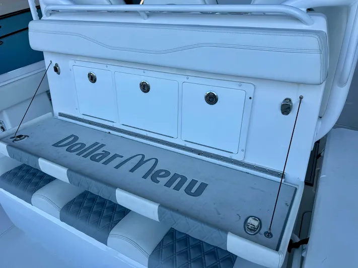  Yacht Photos Pics Invincible 46 Catamaran 2022, white seating area with "Dollar Menu" text on cushion.