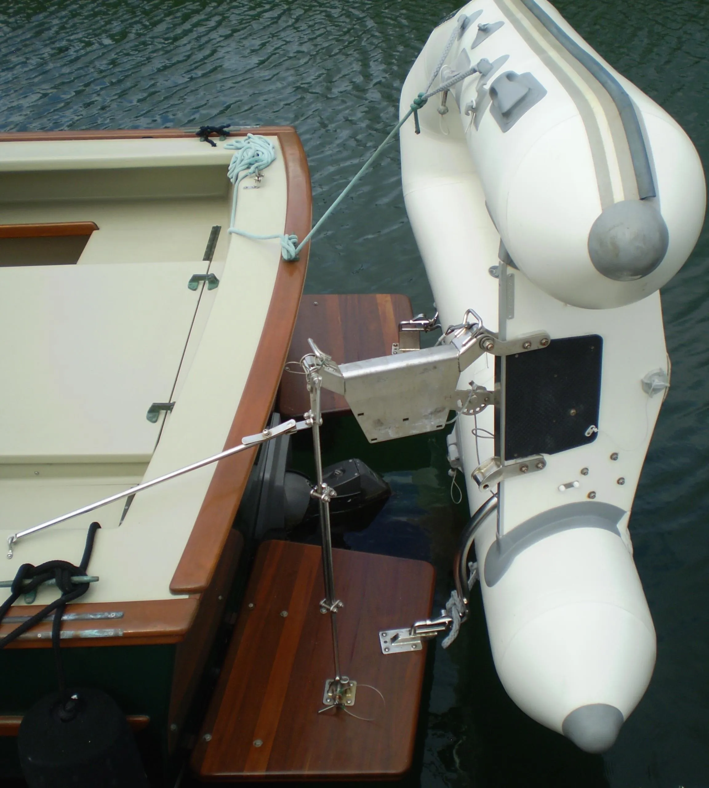 Devlin Surf Scoter 2000 with attached inflatable dinghy on calm water.