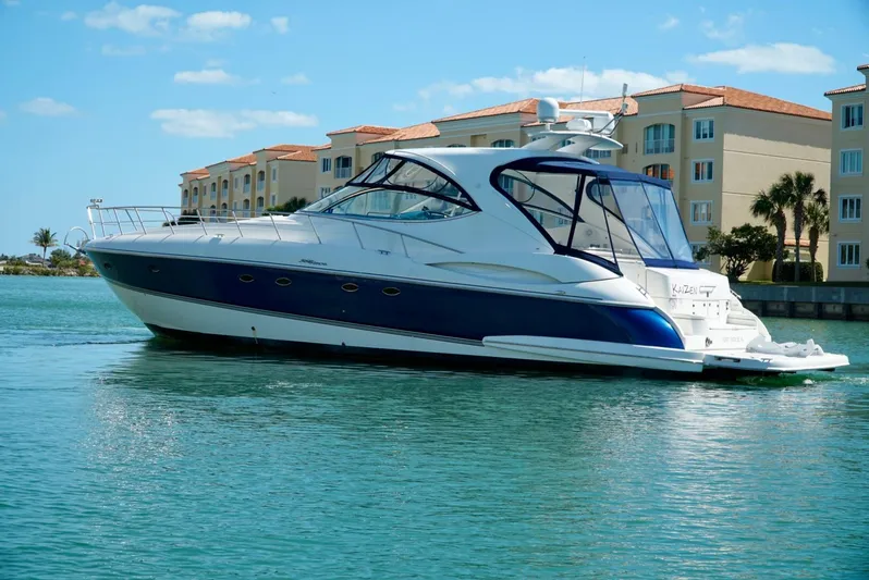 Kaizen Yacht Photos Pics 2007 Cruisers Yachts 560 Express docked near waterfront condos.