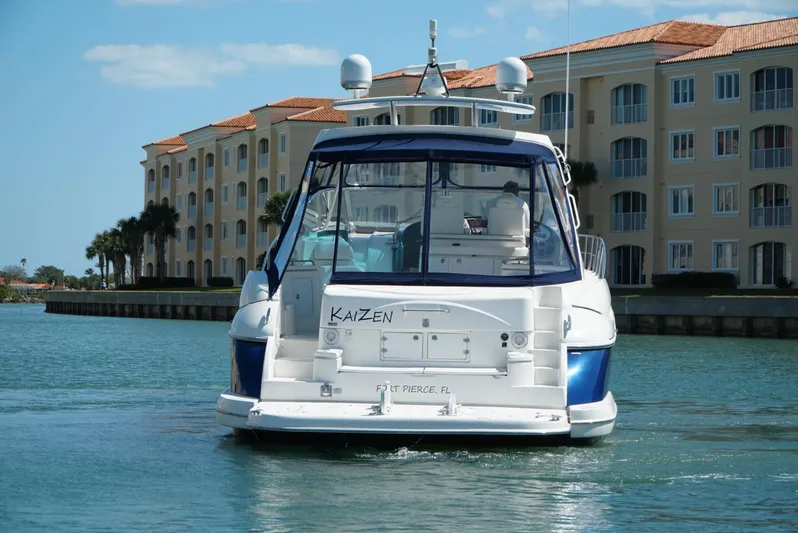 Kaizen Yacht Photos Pics 2007 Cruisers Yachts 560 Express on water near waterfront buildings.