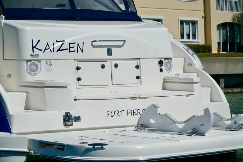 Kaizen Yacht Photos Pics 2007 Cruisers Yachts 560 Express docked, rear view with Kaizen and Fort Pierce text.