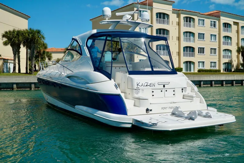 Kaizen Yacht Photos Pics 2007 Cruisers Yachts 560 Express in marina with waterfront buildings.