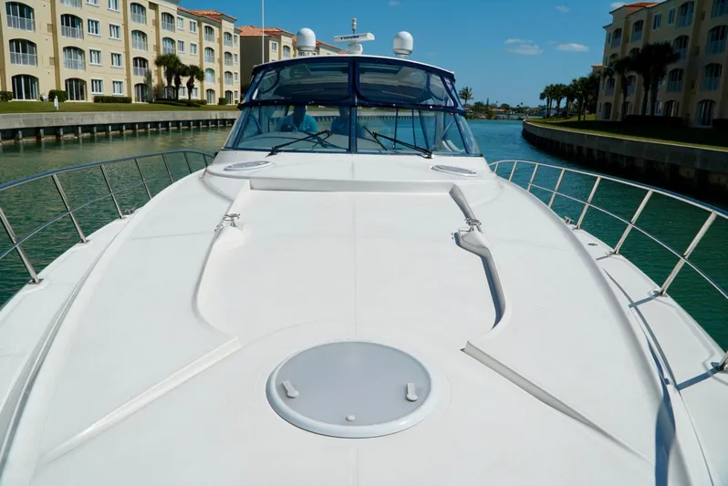 Kaizen Yacht Photos Pics 2007 Cruisers Yachts 560 Express on a sunny day in a canal.