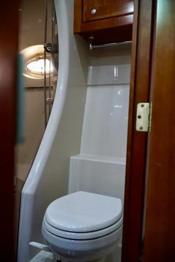 Kaizen Yacht Photos Pics 2007 Cruisers Yachts 560 Express bathroom with modern fixtures and wooden cabinetry.