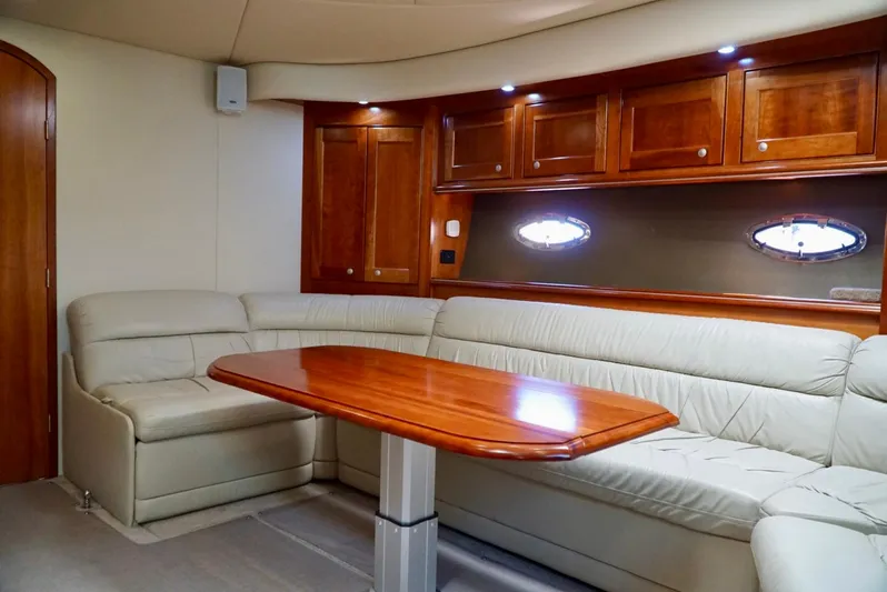 Kaizen Yacht Photos Pics 2007 Cruisers Yachts 560 Express interior with leather seating and wooden table.