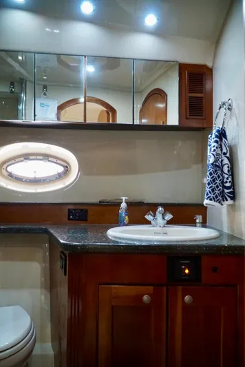 Kaizen Yacht Photos Pics Luxurious bathroom in 2007 Cruisers Yachts 560 Express with modern fixtures and elegant design.