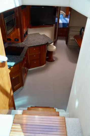 Kaizen Yacht Photos Pics Interior of 2007 Cruisers Yachts 560 Express with wooden cabinetry and modern amenities.